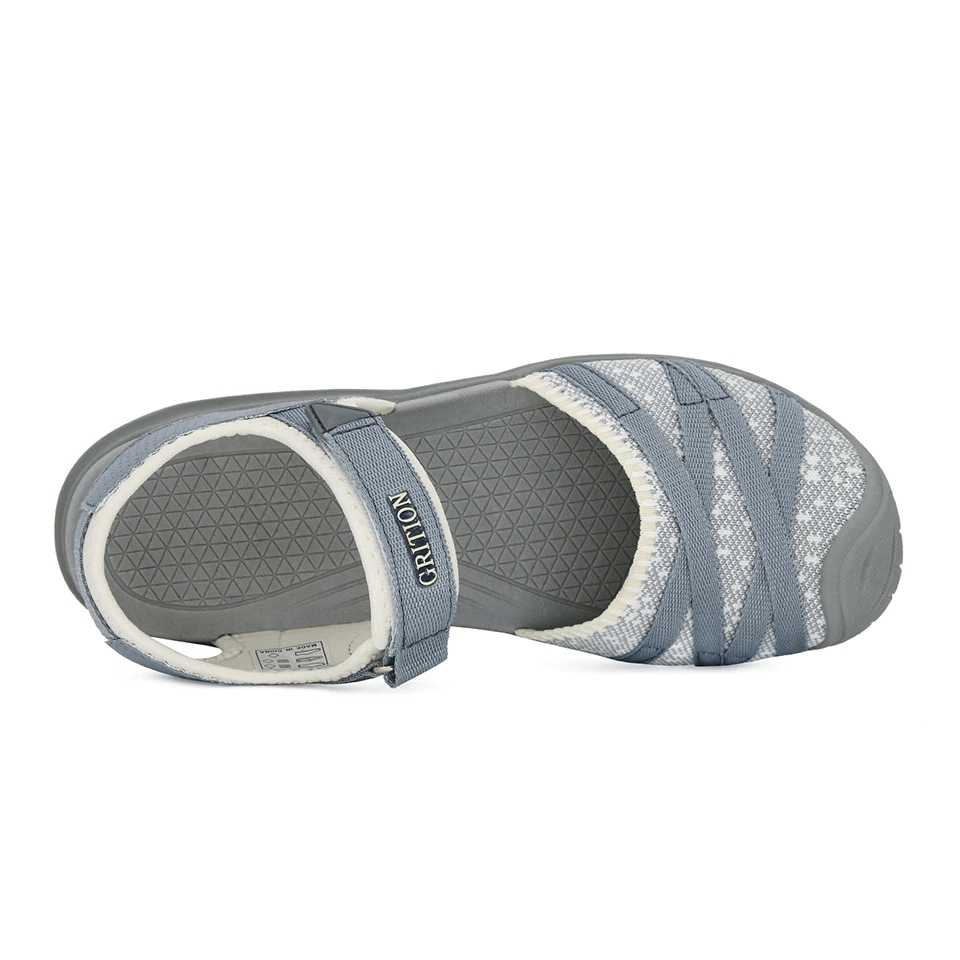 Gray closed-toe flat sandals with a hook & loop closure, perfect for casual wear and outdoor trekking. Lightweight and comfortable design.